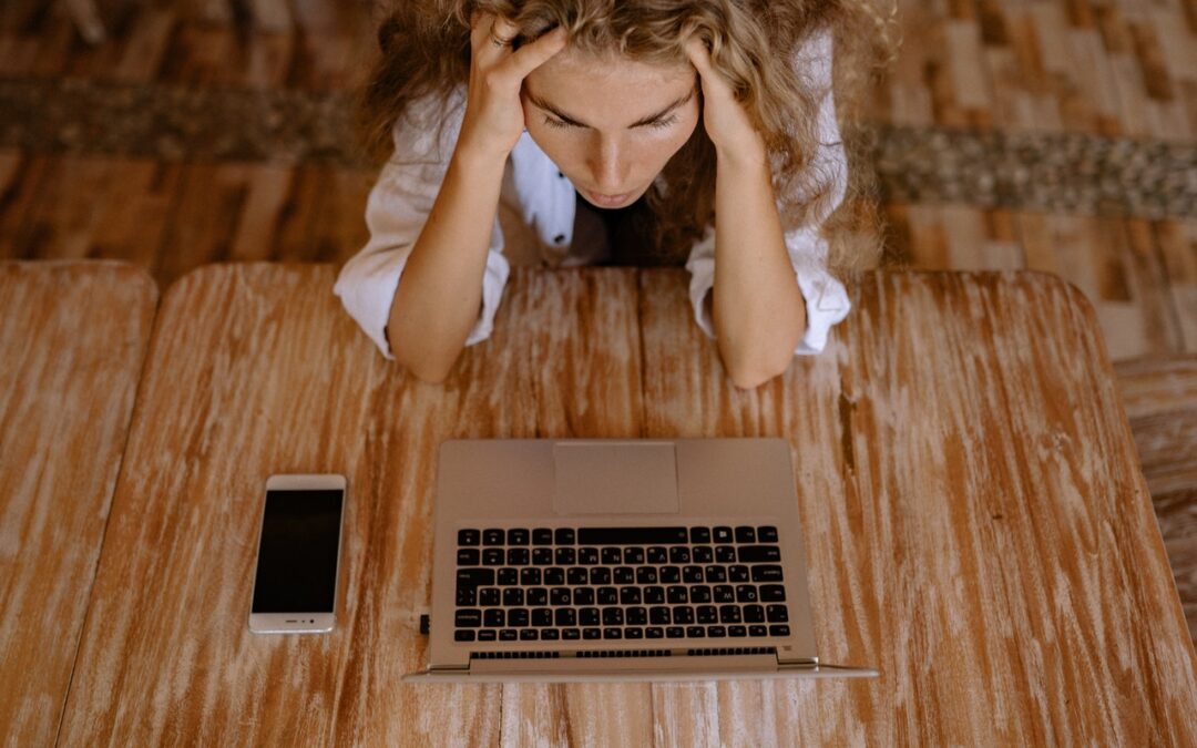 Stressed person sat at a laptop